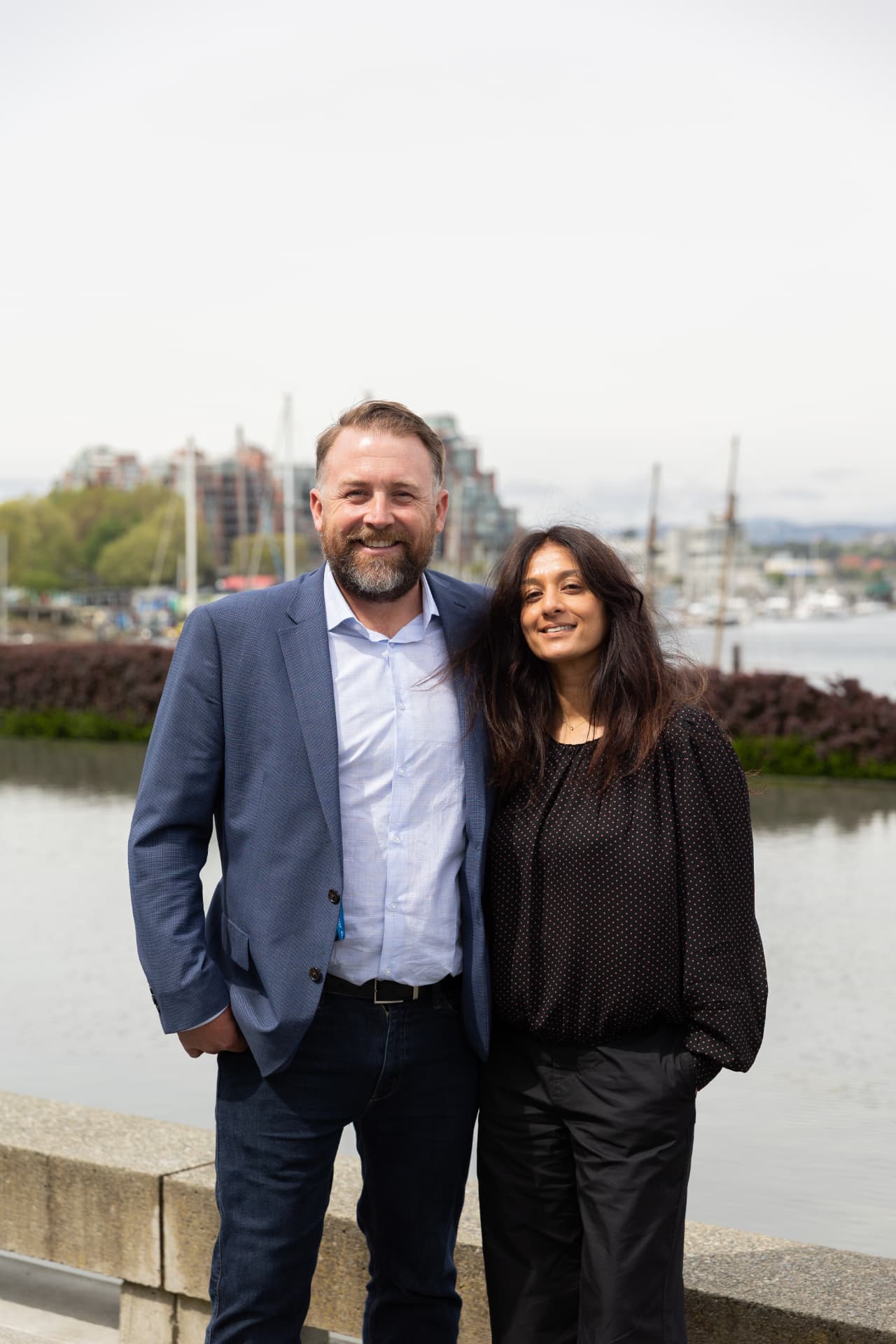 Yasmine Roulleau and Steve Davis, co-founders of Flywheel Ventures Group, standing together at a Vancouver harbour
